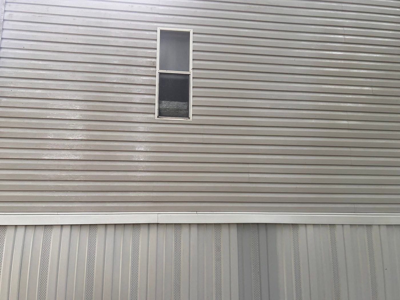 Same siding bright and clean after pressure washing